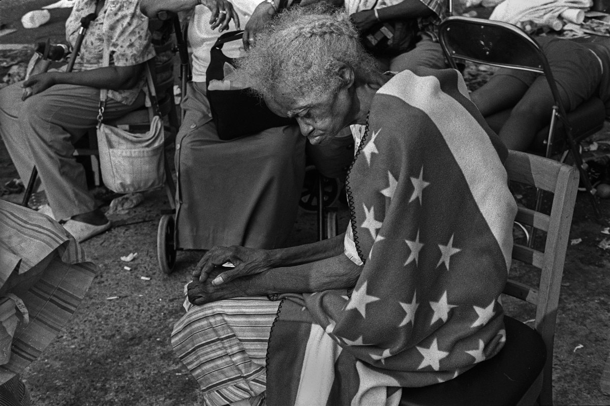New Orleans, LouisianaSeptember 2, 2005Hurricane Katrina: 84-year old Milvertha Hendricks wrapped in an American flag blanket after spending five days on the street at the Convention Center. She was not evacuated until the next day.PHOTOGRAPH by ALAN CHIN