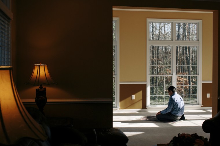 DECEMBER 19, 2015 - FREDERICKSBURG, VA - Muhammed Asif, prays at his home in Spotsylvania, Va. Asif and his wife Saima Rana were planning to vote Republican in the next presidential election due to tax policies, but after hearing anti-Islamic rhetoric from the candidates, they say they will change their votes to Democrat.