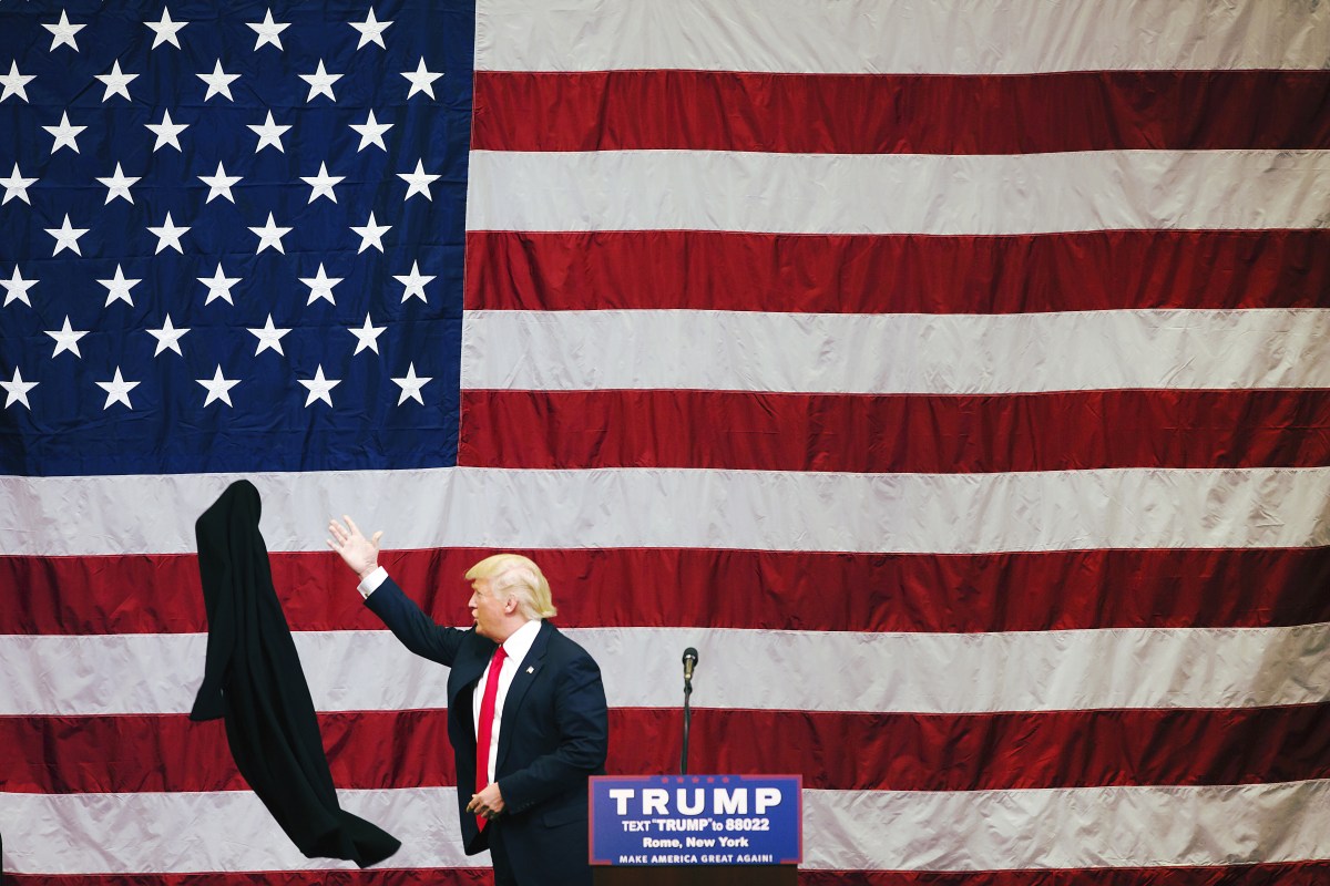 Donald Trump tosses his coat aside during a fly-in campaign stop at the Griffiss International Airport in Rome, N.Y.