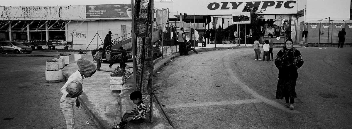 Children play outside the disused Hellinikon International Airport, where stranded refugees and migrants are temporarily housed in Athens.