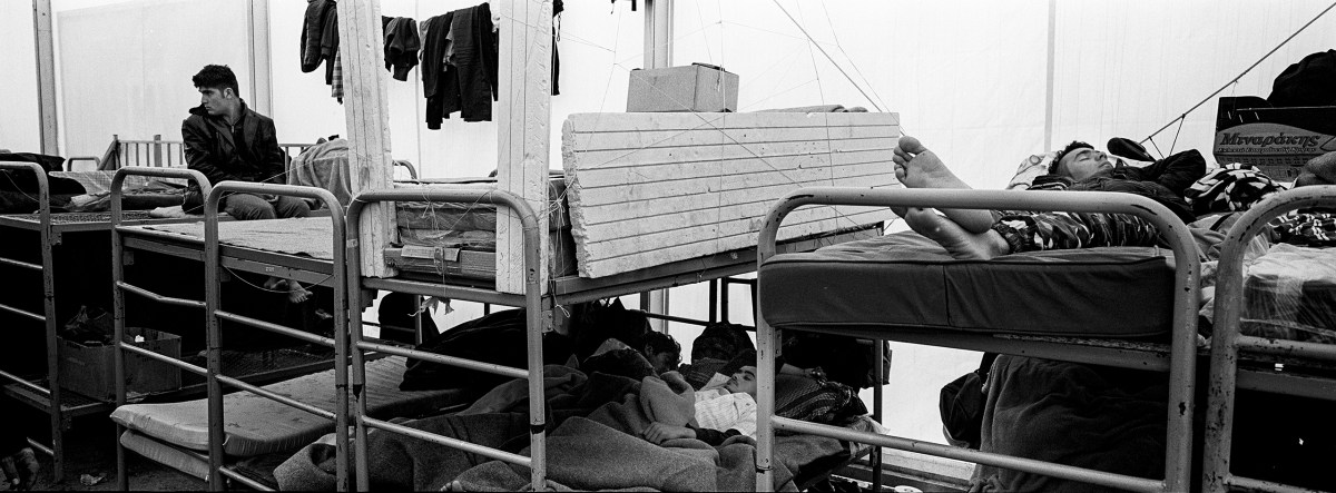 Men from Afghanistan sleep inside a tent at the Schisto camp for refugees and migrants near Athens.