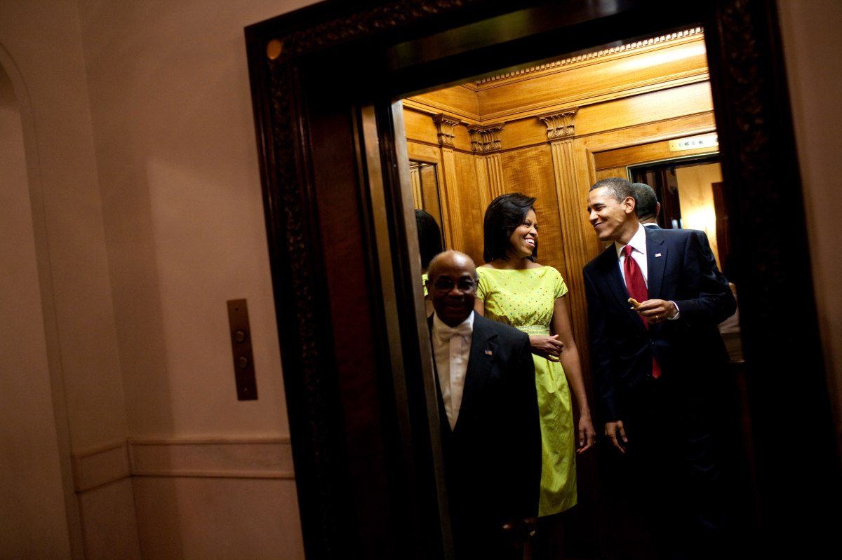 Barack Obama, holding a tortilla from the buffet table at the White House Cinco de Mayo celebration, smiles at Michelle Obama as they get on the elevator to the private residence following the event on May 4, 2009.