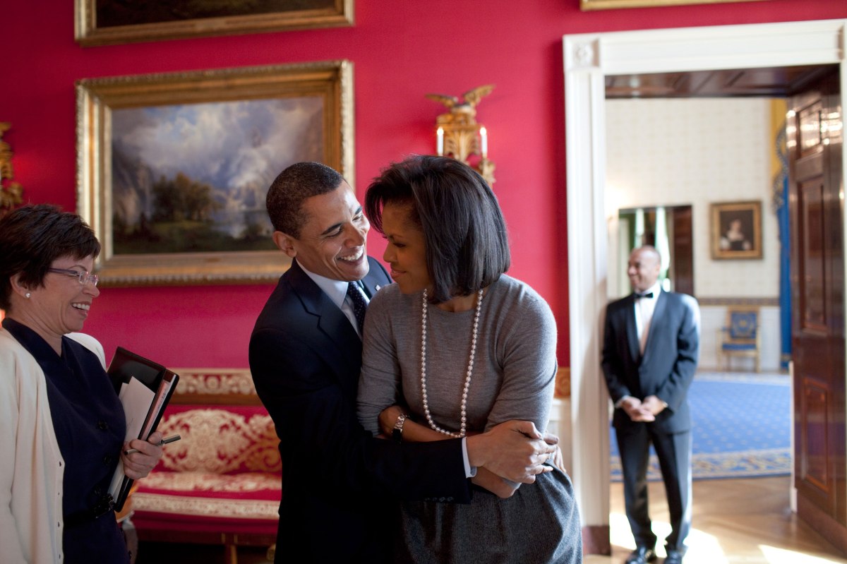 Barack Obama hugs Michelle Obama in the Red Room of the White House prior to the National Newspaper Publishers Association reception on March 20, 2009.