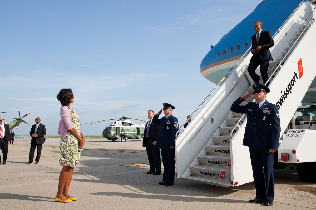 Michelle Obama waits to greet Barack Obama upon his arrival at John F. Kennedy International Airport in New York, N.Y., June 14, 2012.