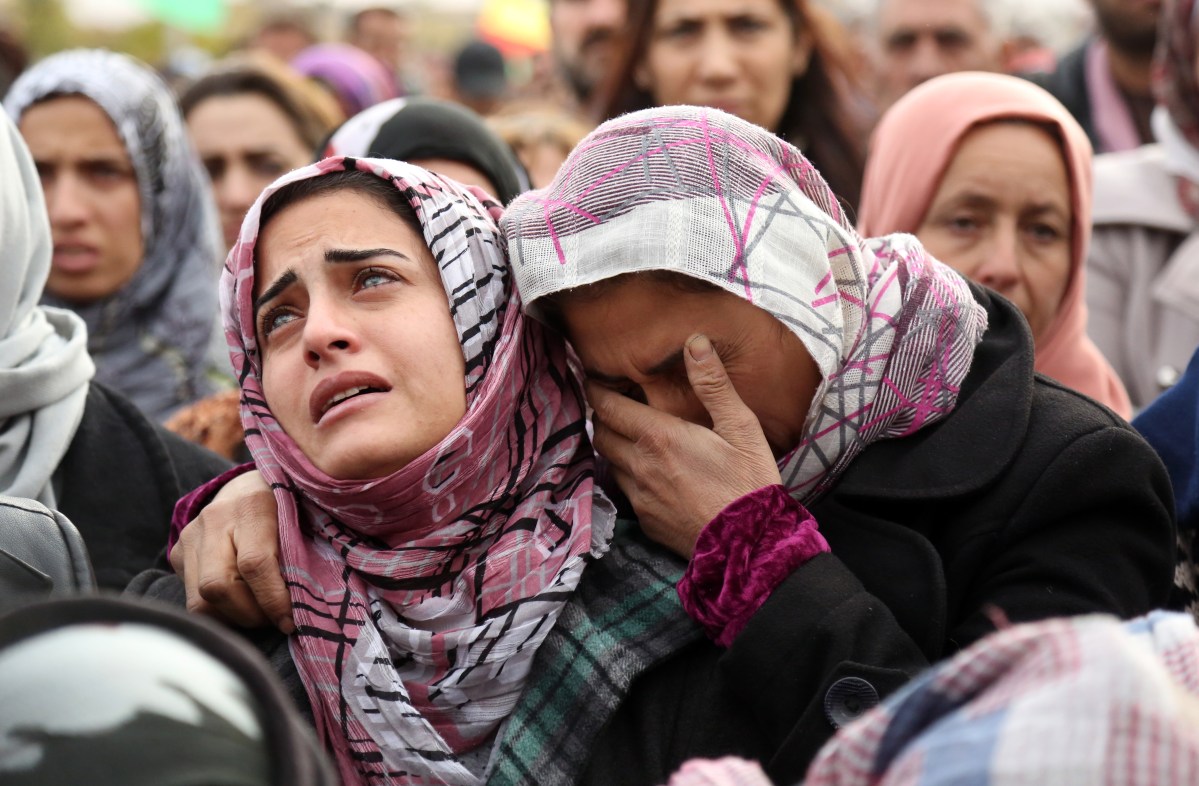 The sister of a man who died in a suicide bombing claimed by ISIS in the nearby town of Tal Tamr mourns during his funeral in Qamishli, in Syria's northeastern Hasakeh province, on Dec. 13, 2015.