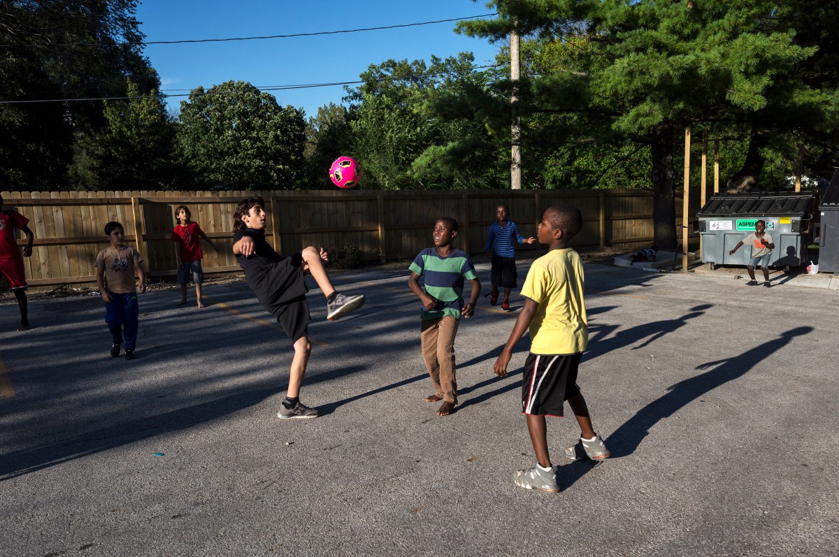 Nazeer plays soccer with other residents of the apartment complex where other refugee families have been settled.