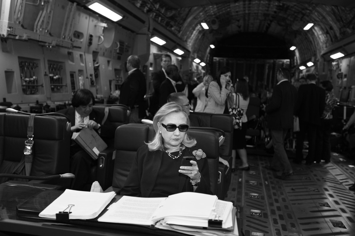 Hillary Clinton checks her messages upon departure from Malta for the as-yet-undisclosed location, Tripoli, Oct. 18, 2011.