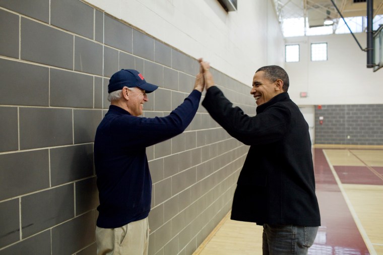 President Barack Obama and Vice President Joe Biden high-five after watching Sasha Obama and Maisy Biden play in a basketball game in Chevy Chase, Md., Feb. 27, 2010. (Official White House Photo by Pete Souza)This official White House photograph is being made available only for publication by news organizations and/or for personal use printing by the subject(s) of the photograph. The photograph may not be manipulated in any way and may not be used in commercial or political materials, advertisements, emails, products, promotions that in any way suggests approval or endorsement of the President, the First Family, or the White House.