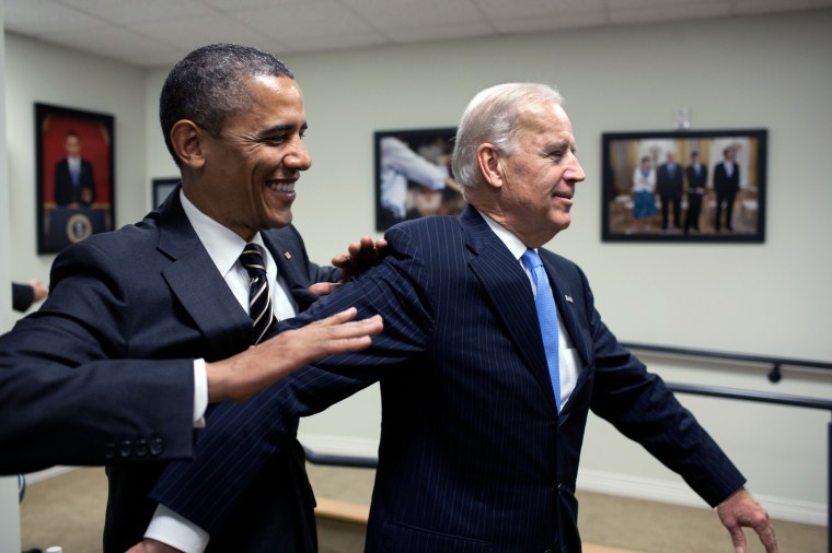 President Barack Obama jokes with Vice President Joe Biden backstage before the STOCK Act signing event in the Eisenhower Executive Office Building South Court Auditorium, April 4, 2012. (Official White House Photo by Pete Souza)This official White House photograph is being made available only for publication by news organizations and/or for personal use printing by the subject(s) of the photograph. The photograph may not be manipulated in any way and may not be used in commercial or political materials, advertisements, emails, products, promotions that in any way suggests approval or endorsement of the President, the First Family, or the White House.