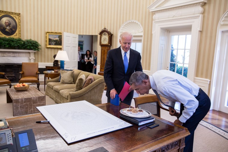 President Barack Obama blows out candles on birthday cupcakes brought to him by Vice President Joe Biden in the Oval Office, Aug. 4, 2016. (Official White House Photo by Pete Souza)This official White House photograph is being made available only for publication by news organizations and/or for personal use printing by the subject(s) of the photograph. The photograph may not be manipulated in any way and may not be used in commercial or political materials, advertisements, emails, products, promotions that in any way suggests approval or endorsement of the President, the First Family, or the White House.