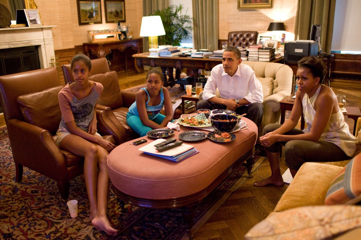 In this official White House photograph, President Barack Obama and his daughters Sasha and Malia watch the World Cup soccer game between the U.S. and Japan, from the Treaty Room office in the residence of the White House, July 17, 2011.