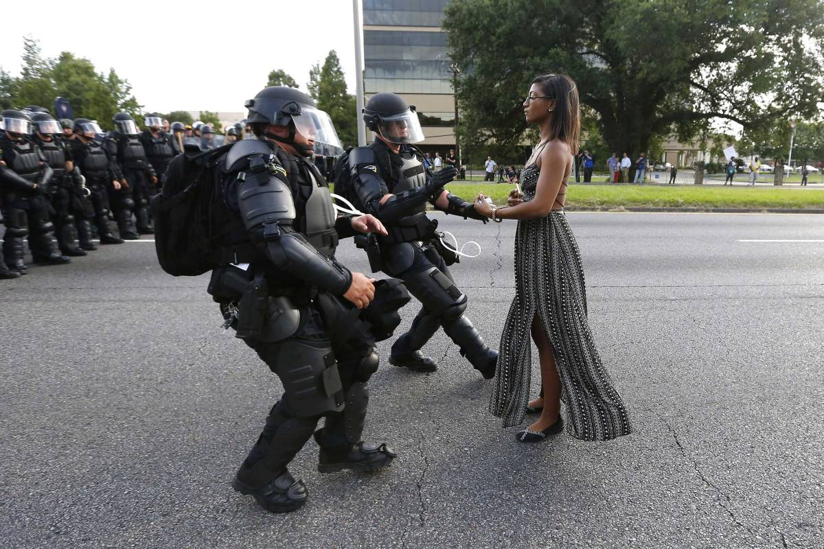 A demonstrator, named Ieshia Evans, protesting the shooting death of Alton Sterling is detained by law enforcement near the headquarters of the Baton Rouge Police Department in Baton Rouge, La, on July 9, 2016.