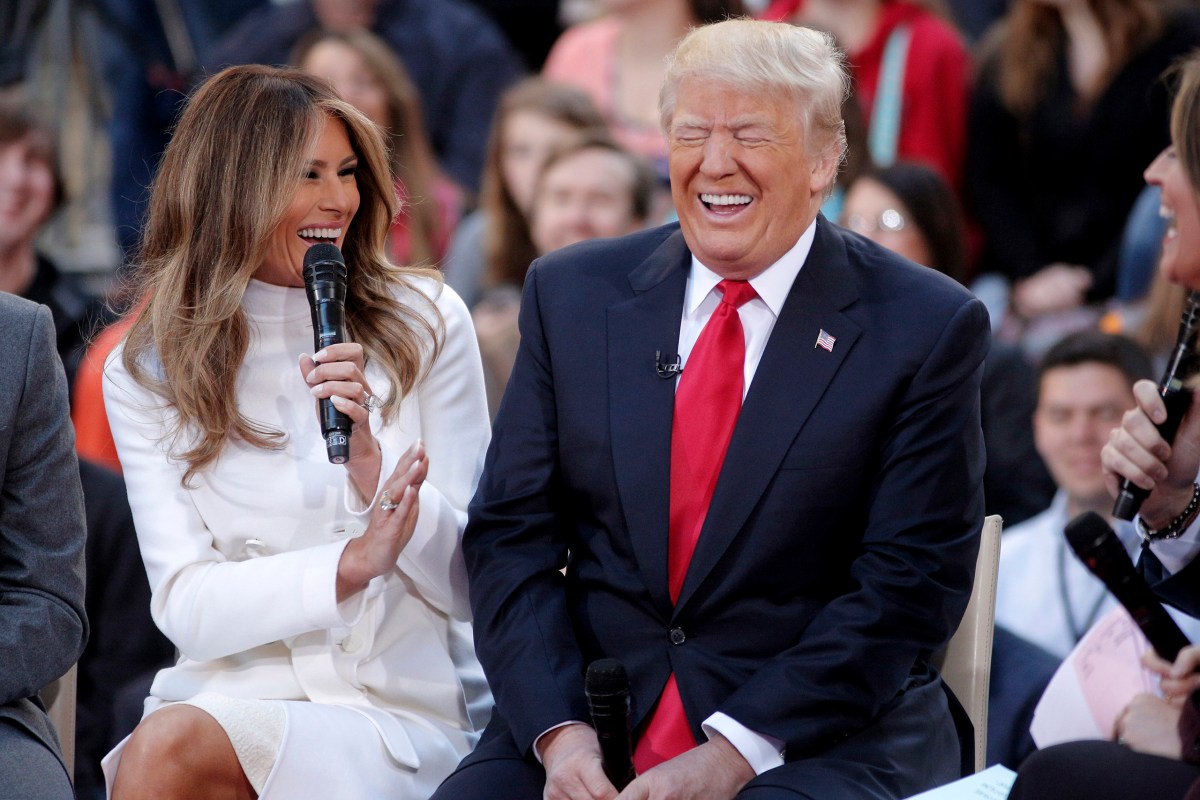 Donald Trump reacts to an answer his wife Melania gives during an interview on NBC's