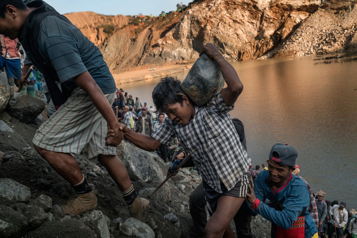 Miners find a jade stone among the discarded tailings at a Hpakant quarry; the slopes are dangerous, and deadly landslides often occur.