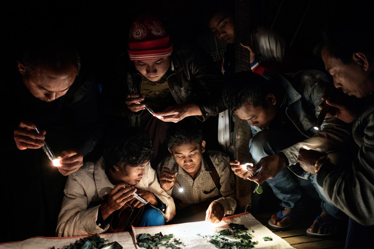 Traders at a market in Mandalay, a city in central Myanmar, use flashlights to examine the color of the jade being sold and to check for cracks.