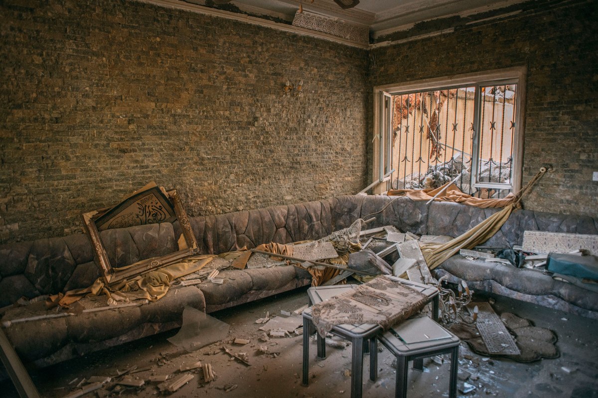 The house of Median Hikmat Al-Galou was destroyed during fighting between the Iraqi special forces and ISIS in the al-Aqeedat district of southwest Mosul. The man, posing with his son on March 29, said ISIS gunmen barged into his home in late February, moved in and then took his family hostageâ€”even using them as human shields.