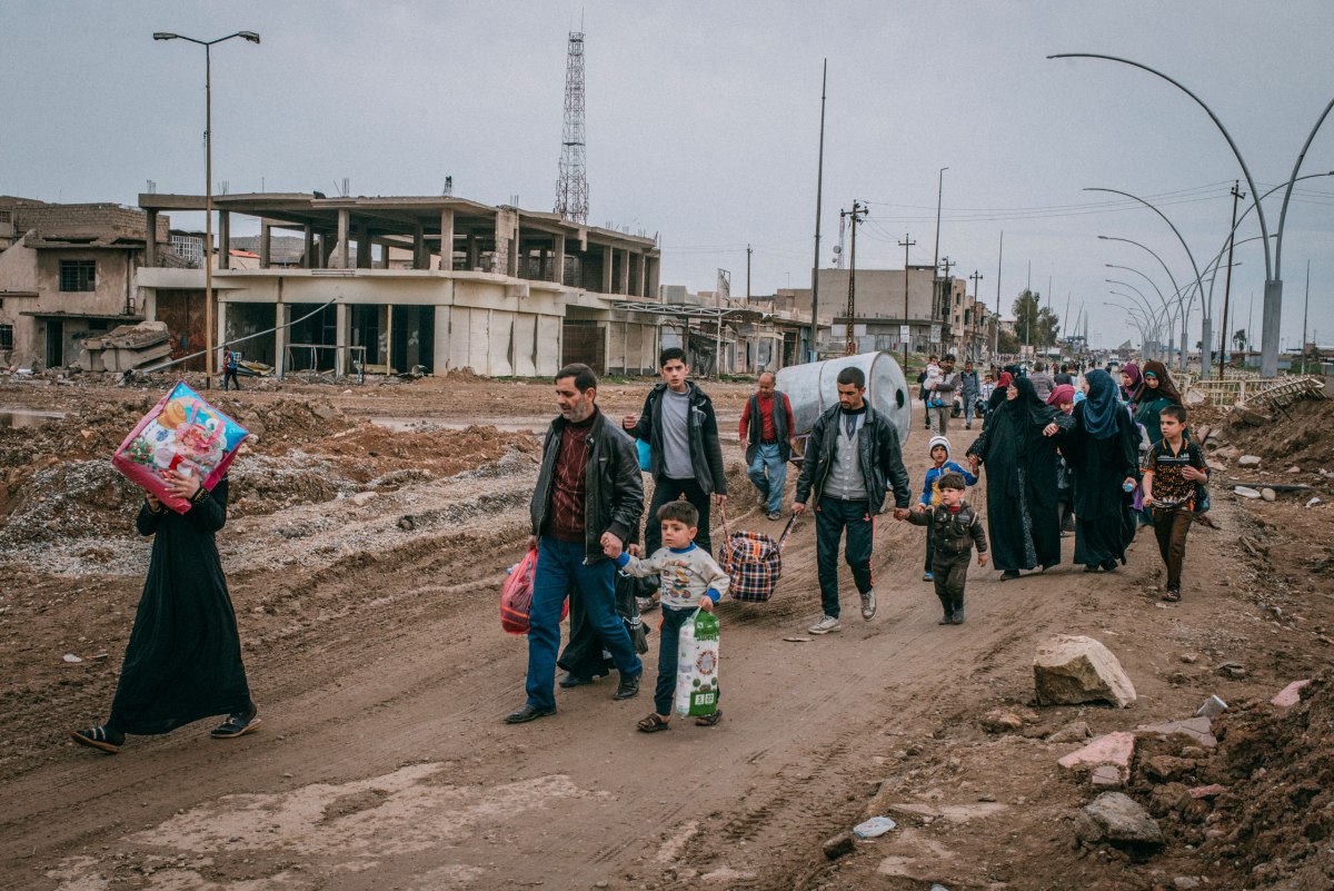 Civilians return via Baghdad Road to a liberated neighborhood in southwest Mosul on March 31.