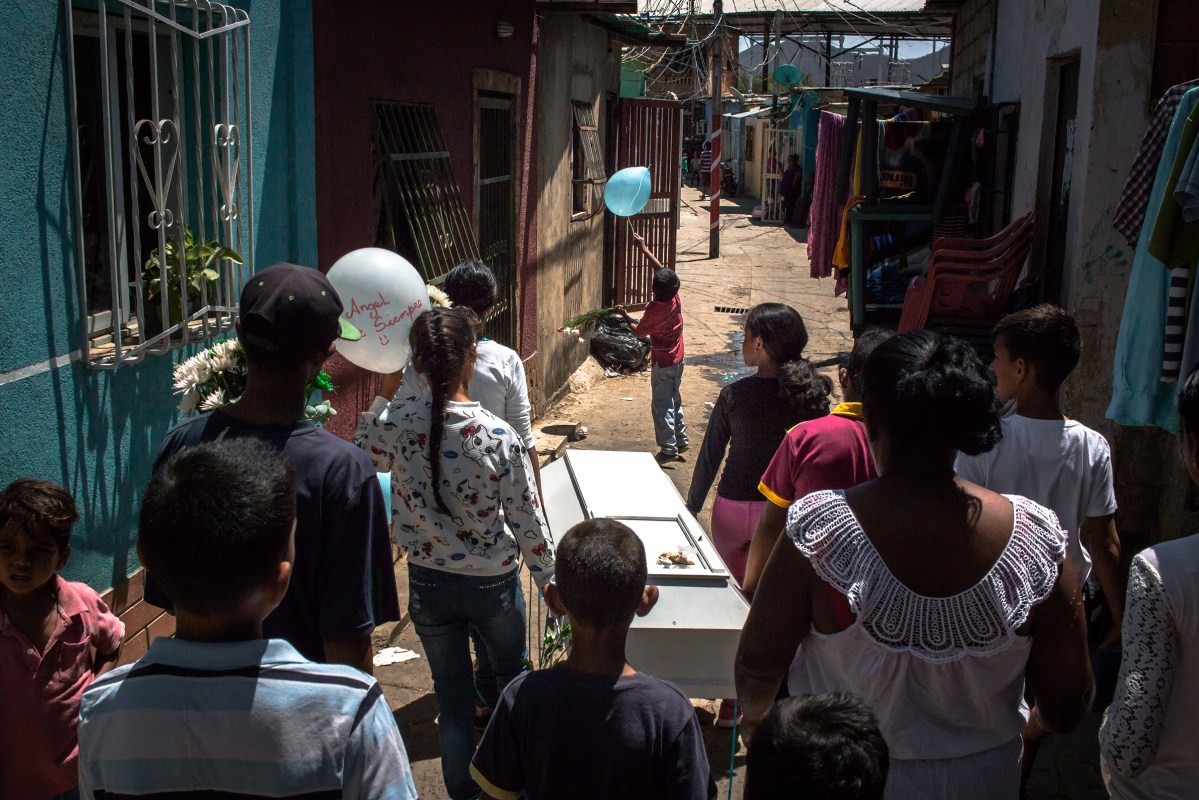 The casket of Angel is carried before burial in Puerto La Cruz, Venezuela, on Feb. 22, 2017. Andrea Hernandez