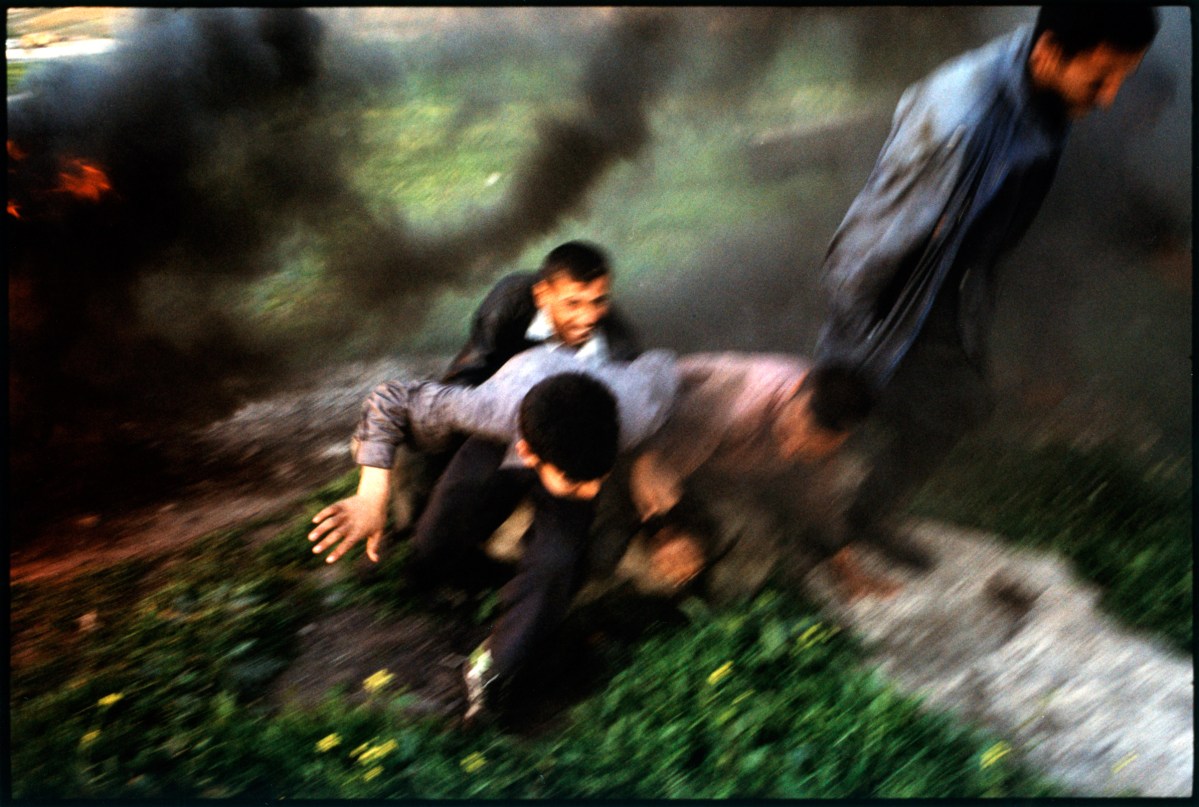 Iraq, Tikkirt, people running away from bombing, elevated view. Stanley Greene—NOOR