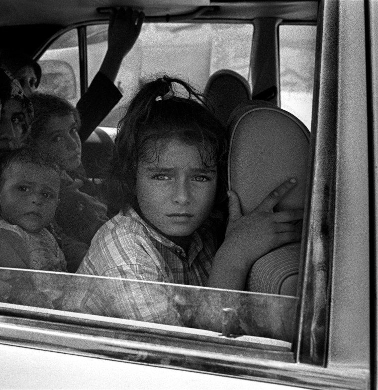 Lebanon, 31 July 2006During the ceasefire, coming out of southern Lebanon a child looks out her car window, mirroring the horror she's seen for the last 22 days.Liban, 31 juillet 2006Pendant le cessez le feu, ?vacuant le sud Liban, une enfant regarde par la fenêtre de sa voiture refl?tant les horreurs qu'elle a vu au cours des 22 derniers jours.© Stanley Greene / Noor. Stanley Greene—NOOR