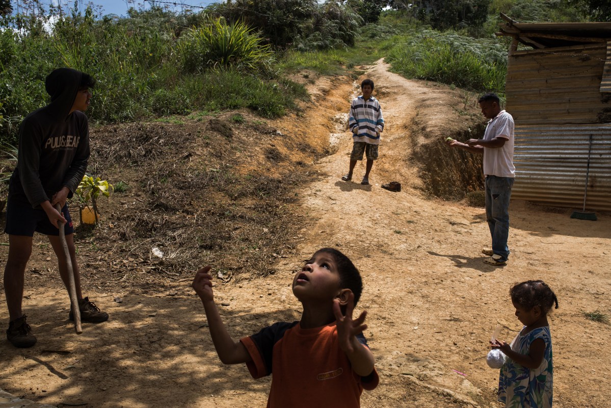 Family members play baseball out of their house in Turgua, a rural area near to Caracas, March 18, 2017. Wil Riera