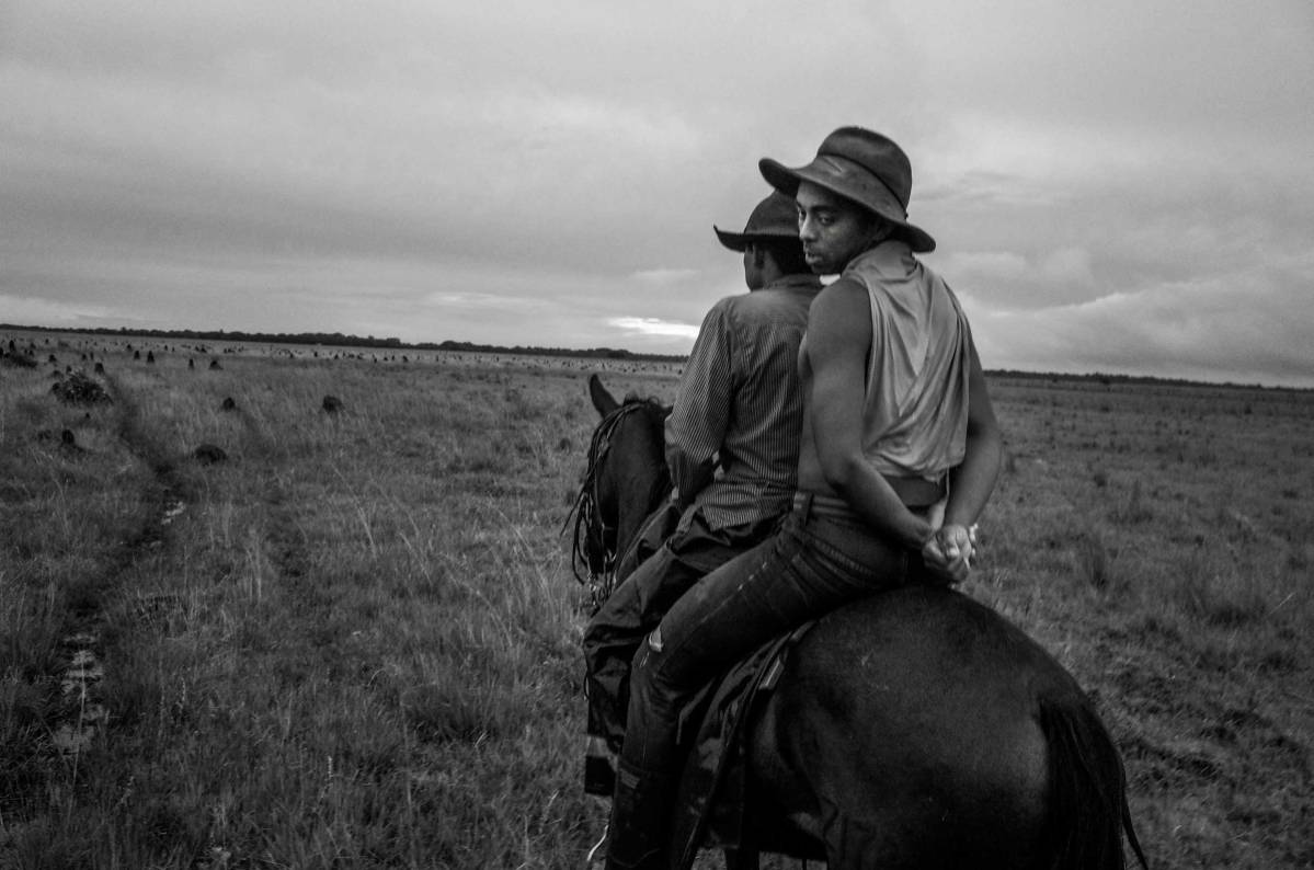 A Llanero shares a companion’s horse after his own horse grew overtired during the Trabajos del Llano. Santana Ranch Savannahs , Casanare State, The Orinoco Plains, Colombia, 2015.