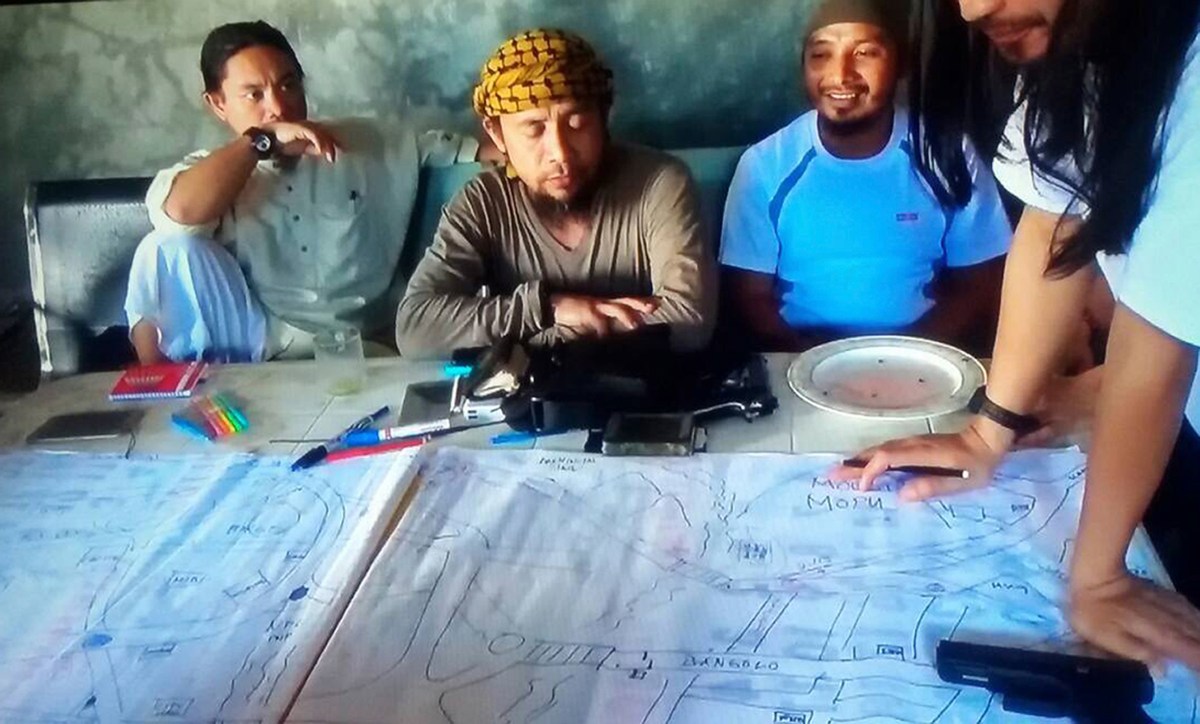 A screengrab from an undated video shows the purported leader of the Islamic State group Southeast Asia branch, Isnilon Hapilon, center, at a meeting of militants at an undisclosed location. AP