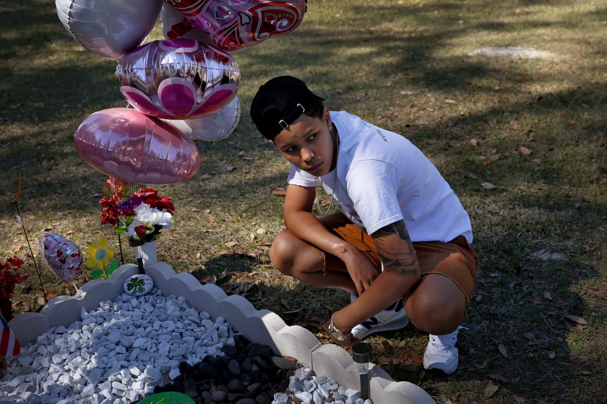Kaliesha Andino, 19, visits the grave of her friend Omar eight months after the Pulse shooting in Orlando, Fla., on Sunday, February 12, 2017. Luis Omar Ocasio-Capo was 20 when he was killed during the shooting. They had been friends since middle school.(Photo by Preston Gannaway © 2017)