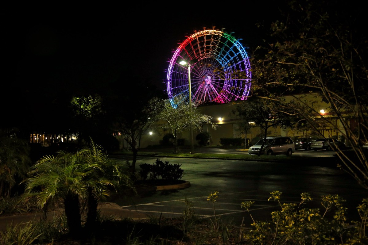 <span class="credit">Preston Gannaway</span><span class="caption">The Orlando Eye lights up in Pride colors on the six month anniversary after the Pulse shooting in Orlando on December 12, 2016. </span>