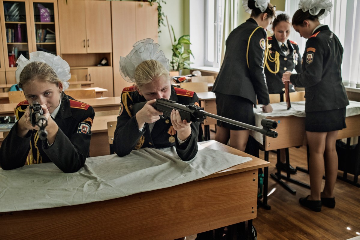 Young girls learn how to assemble and shoot rifles at a cadet boarding school in Moscow.