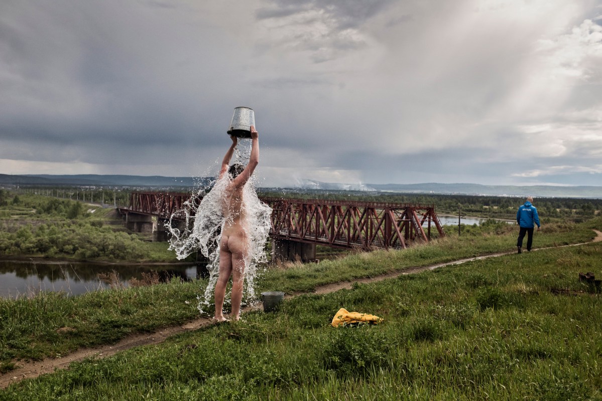 17-year-old Dmitri pours cold water over his body at a rehabilitation clinic on the outskirts of Irkutsk, Russia, June 2015. The use of synthetic drugs is on the rise in Russia, becoming an epidemic in certain parts of the country and straining the state’s ability to offer rehab.