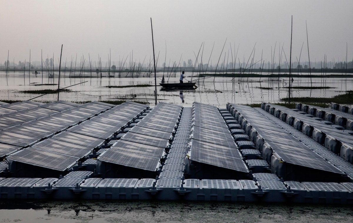 A local fisherman passes a section of floating panels.