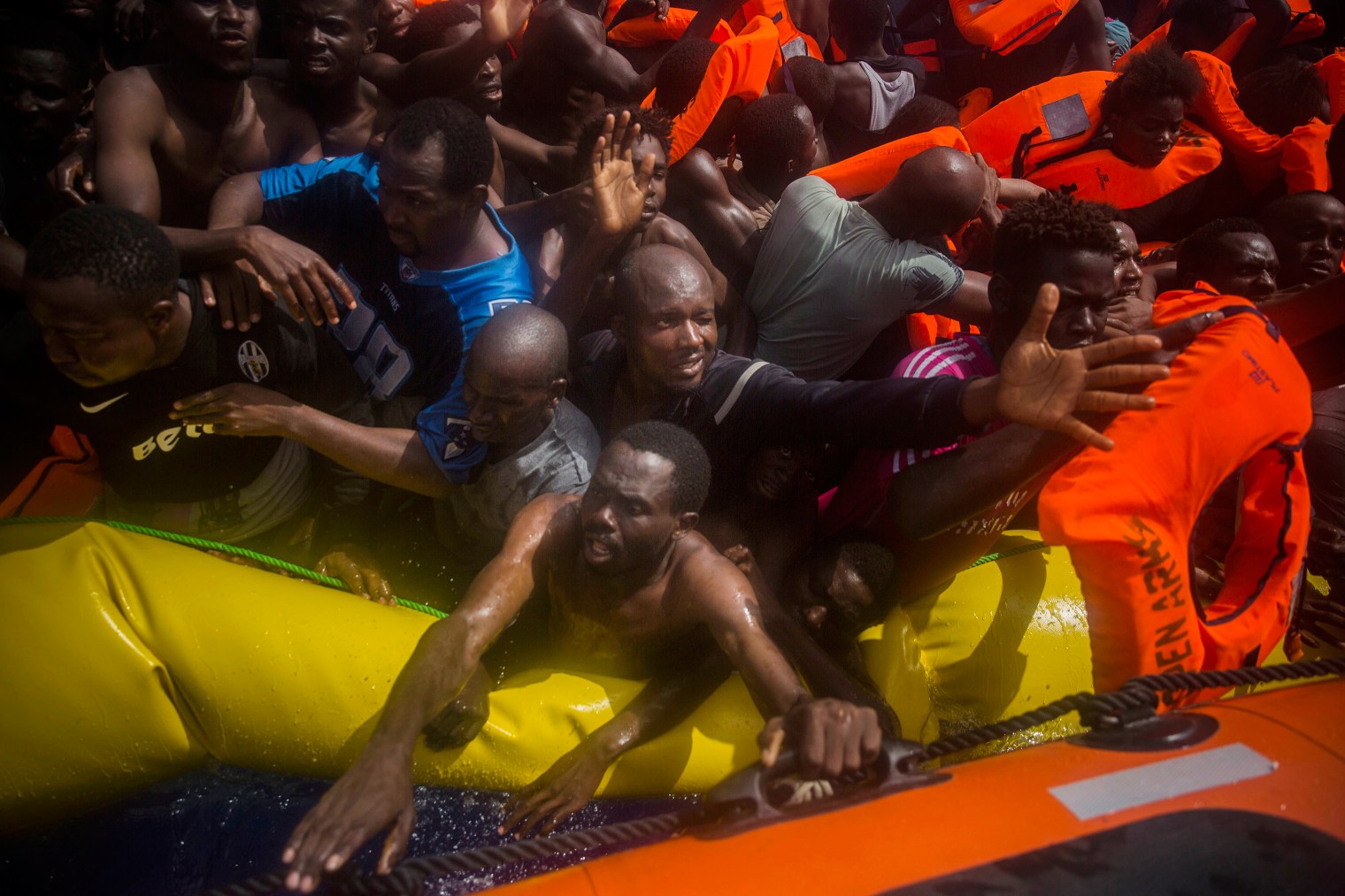 Migrants receive life jackets during the rescue.
