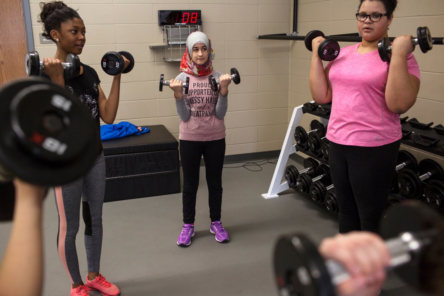 Sedra Tameem lifts weights during gym class at Waukee Middle School. Waukee is a suburb of Des Moines, Iowa.
