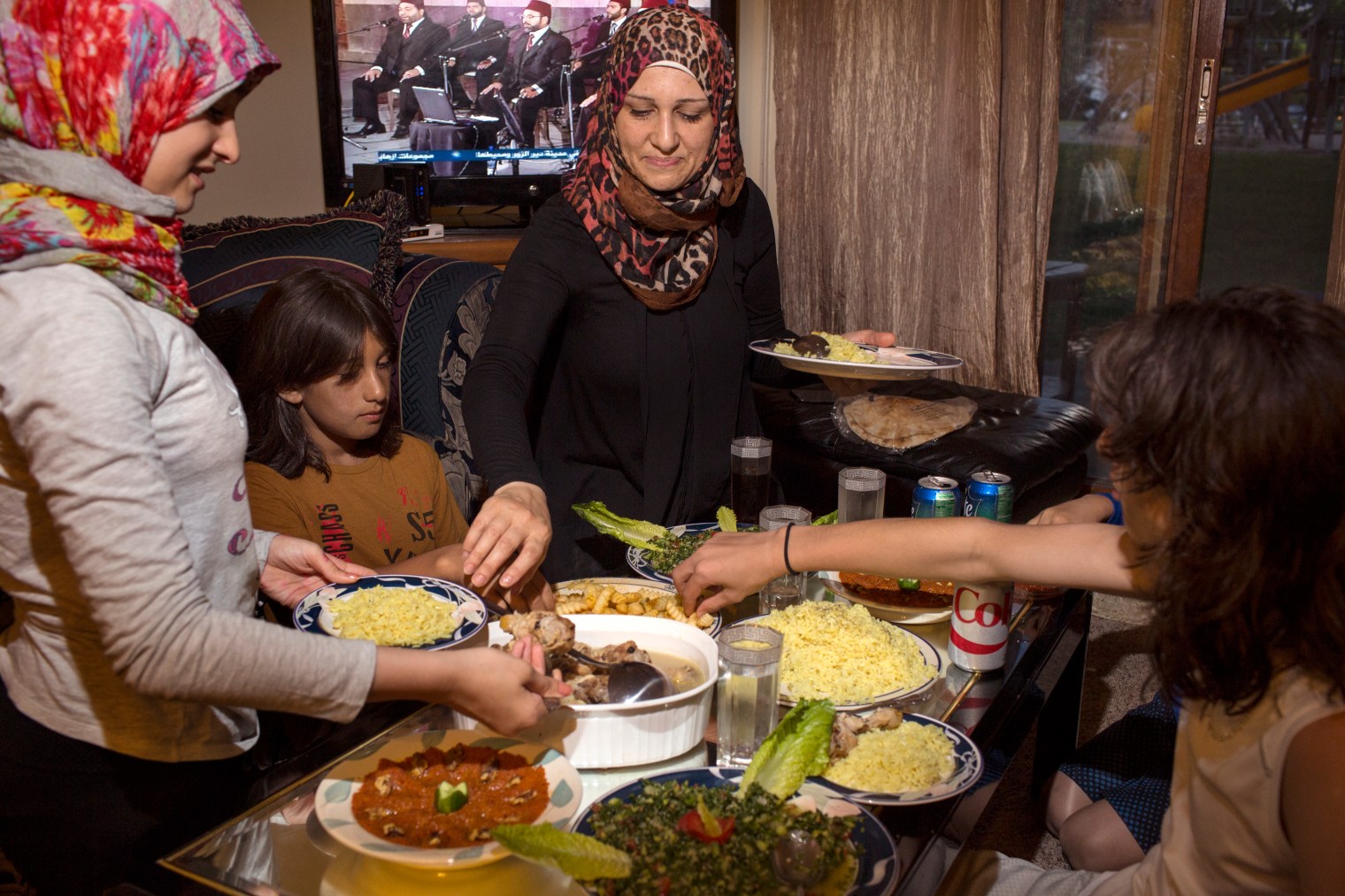 Ghazweh Aljabooli and her children eat together after breaking their fast during Ramadan at their apartment in West Des Moines, Iowa.