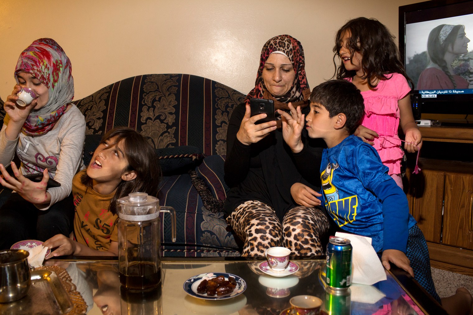 Ghazweh Aljabooli and her children, Sedra, Haidar, Mutaz and Hala (left to right) after breaking their fast during Ramadan at their apartment in West Des Moines, Iowa.