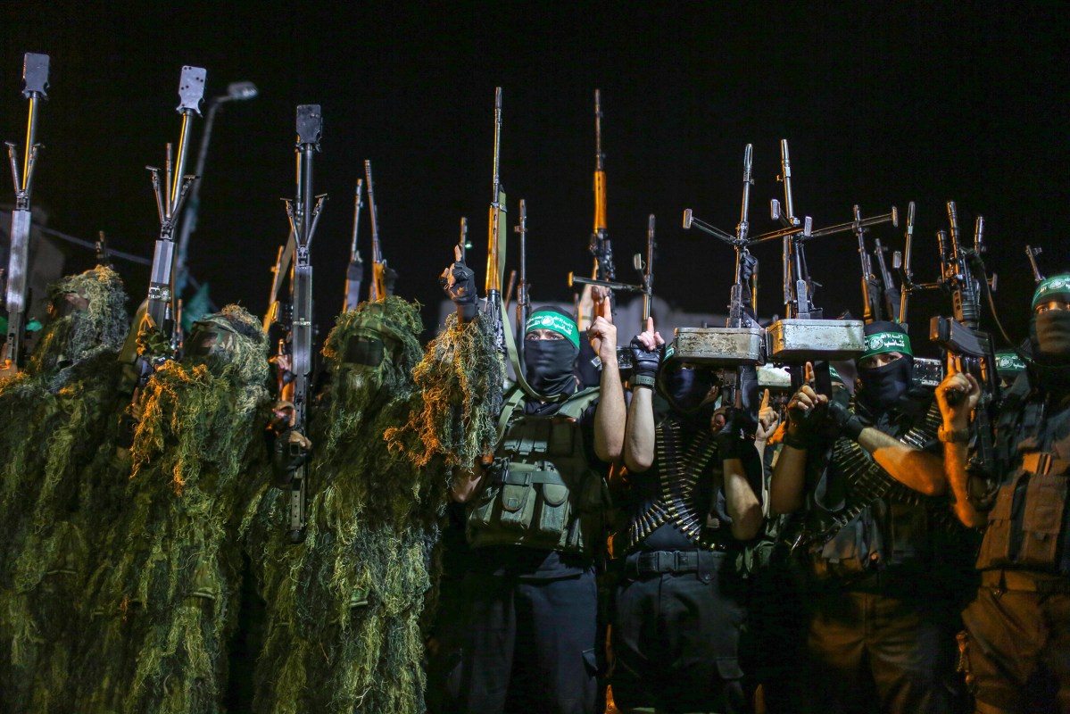 Masked Palestinian gunmen from Izzedine al-Qassam Brigades, a military wing of Hamas, march during a rally marking the first anniversary of the Israeli war on Gaza, in central Gaza City on July 8, 2015.