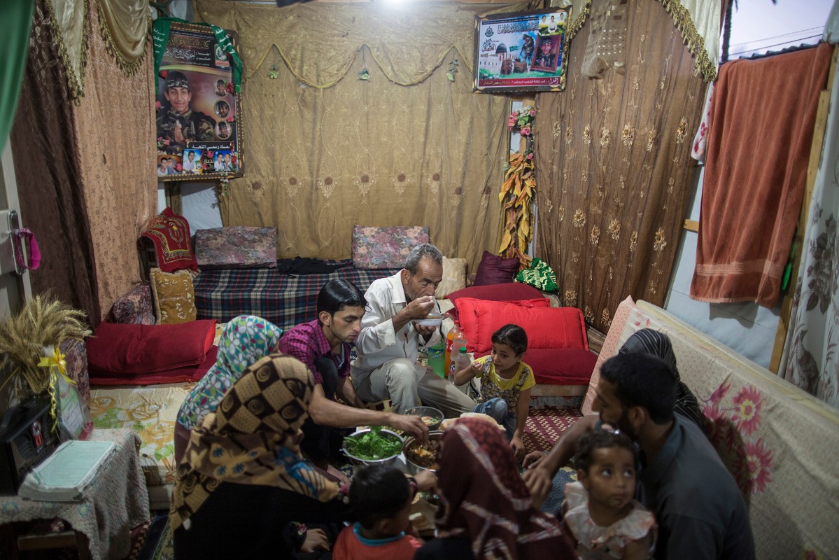 Al-Najjar family are breaking their fast at a cravan where they are staying since their house was demolished last summer on July , 6 2015.