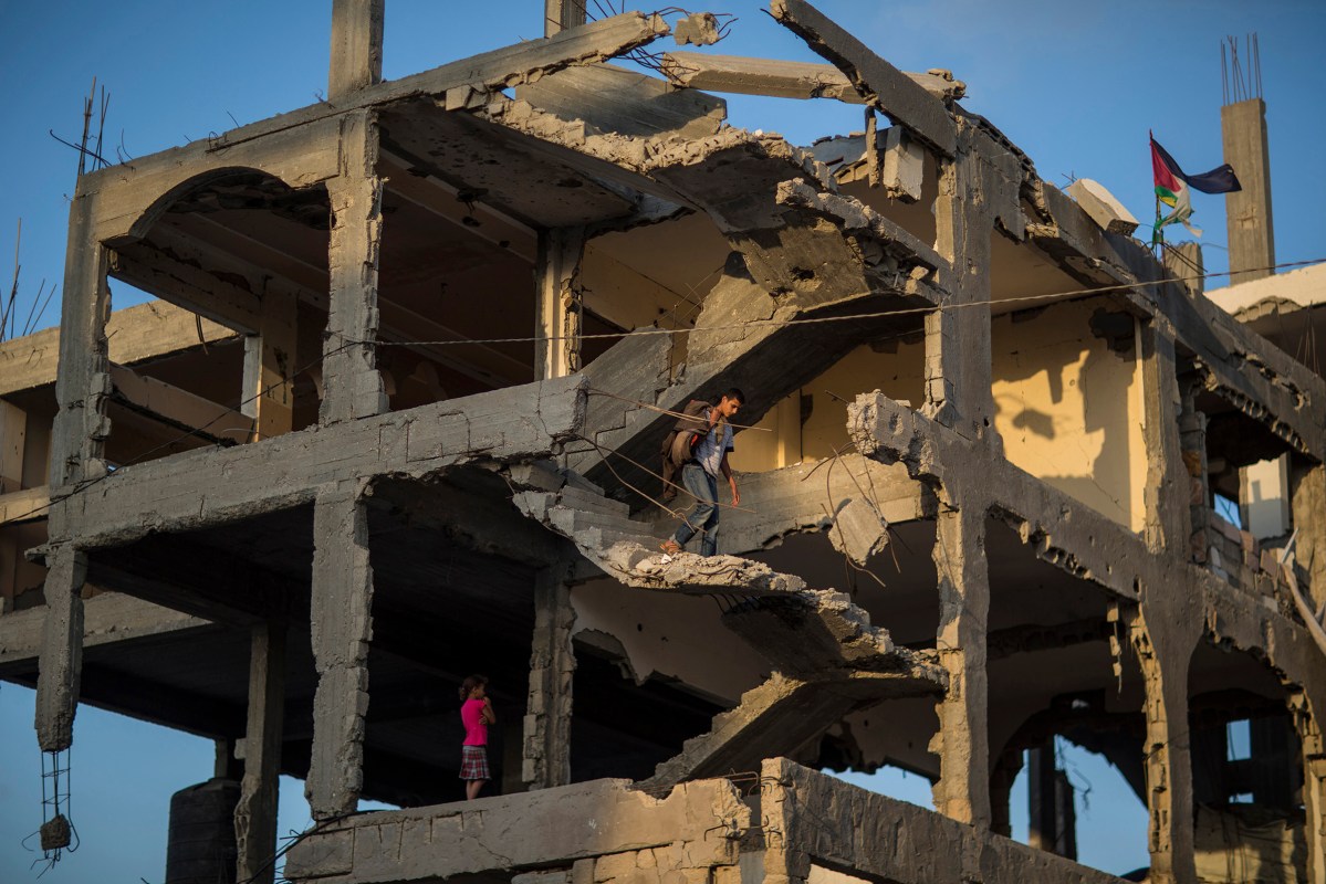 Ahmed Atawna going down at the stairs of their demolished house in Al-Shaaf area. The family live in a tent near the damaged house. in the east of Gaza on, 01 July 2015. By Wissam Nassar.