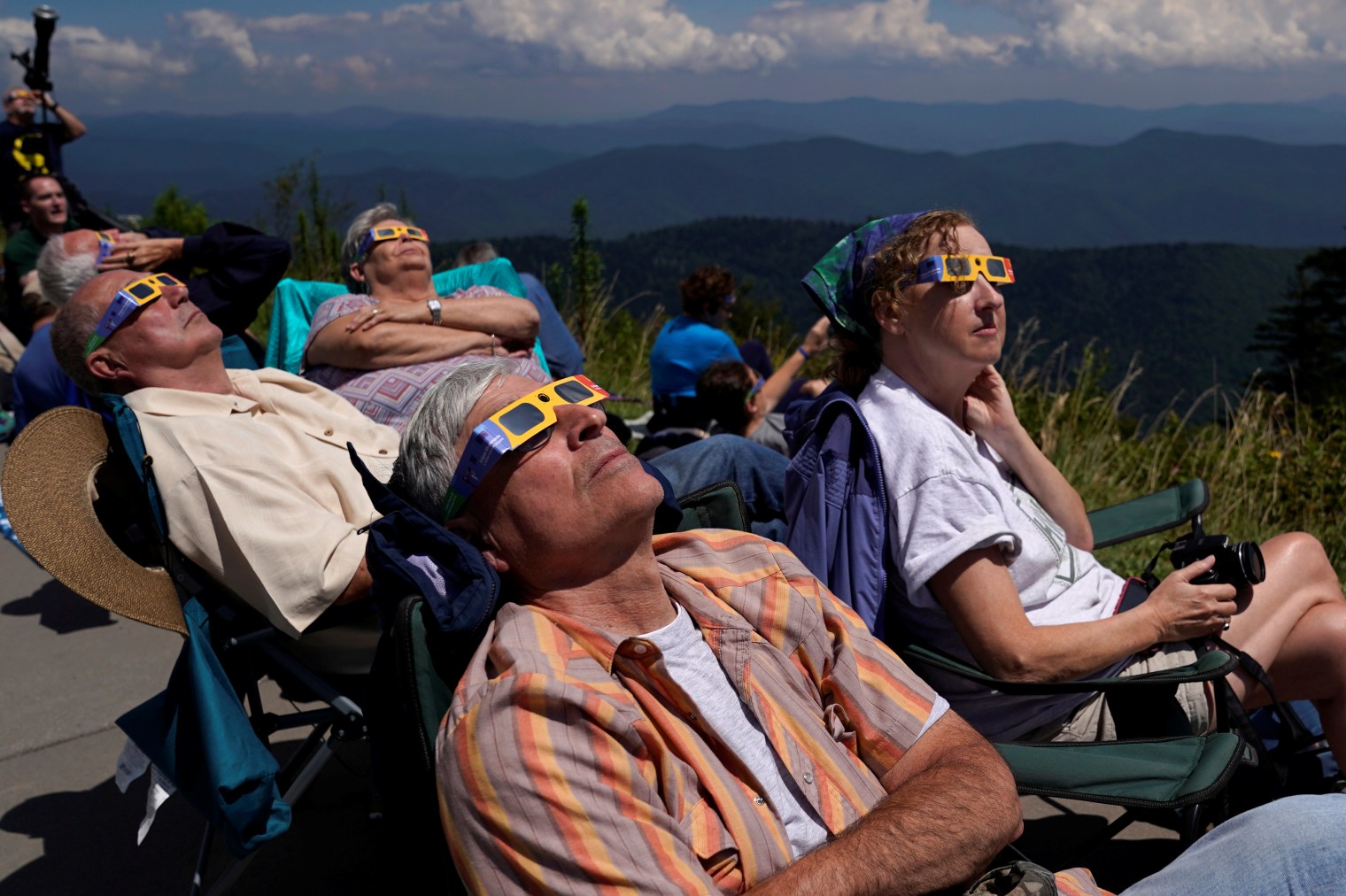 People watch as the solar eclipse approaches totality from Clingmans Dome, which at 6,643 feet (2,025m) is the highest point in the Great Smoky Mountains National Park, Tennessee on Aug. 21, 2017. 