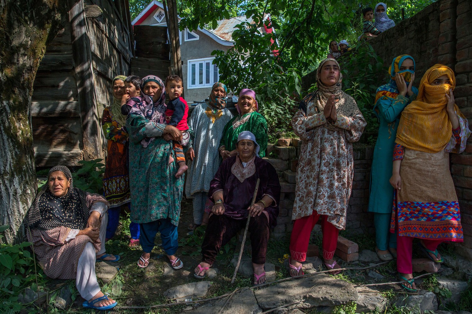 Women grieve as they watch the funeral procession of rebel leader Sabzar Ahmed Bhat in Retsuna, 45 Kilometers south of Srinagar on May 28, 2017. Thousands of people assembled in southern Tral area to take part in the funeral of the rebel leader Sabzar Ahmed Bhat, chanting slogans calling for Kashmir's freedom from Indian rule.