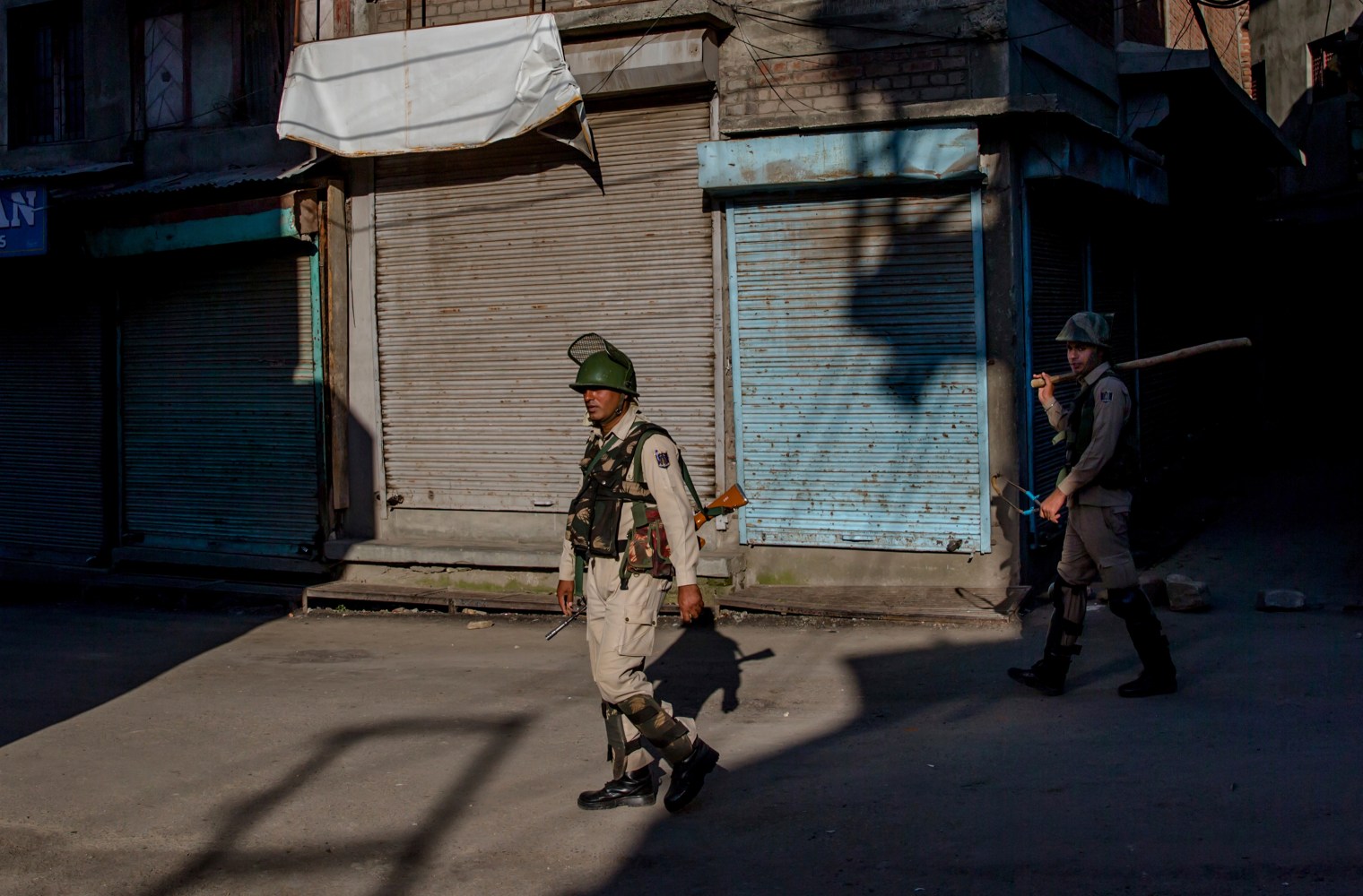 Indian paramilitary soldiers patrol during curfew in downtown area of Srinagar on June 23, 2017. Authorities imposed stringent curfew in old parts of Srinagar and did not allow Friday prayers at the Jamia Masjid to stop anti India protests. The last Friday of the fasting month of Ramadan is observed as "Al-Quds Day" and "Kashmir Day" in the region in solidarity with Palestinians and Kashmiris.