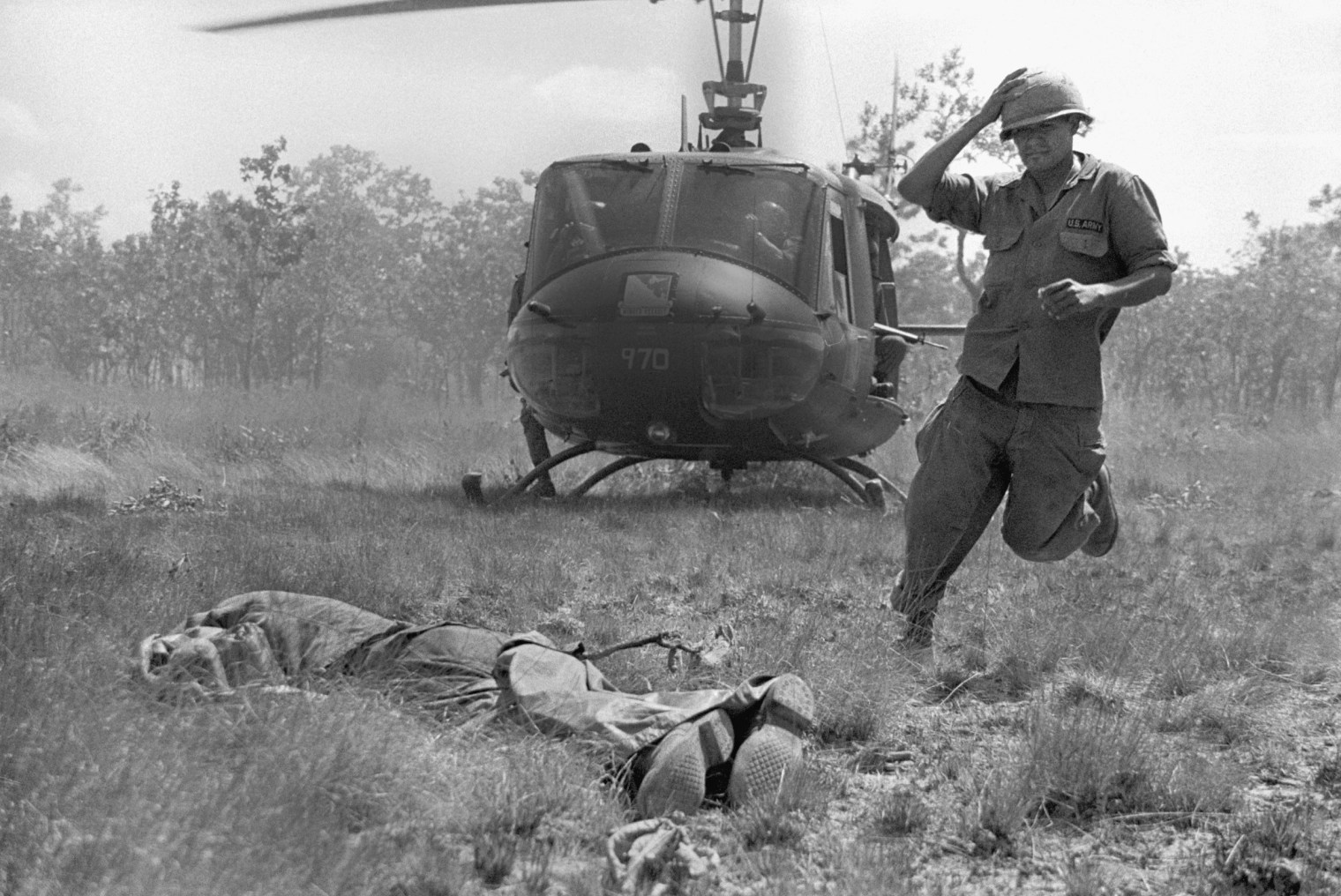Soldier Picking Up Dead Body In Vietnam