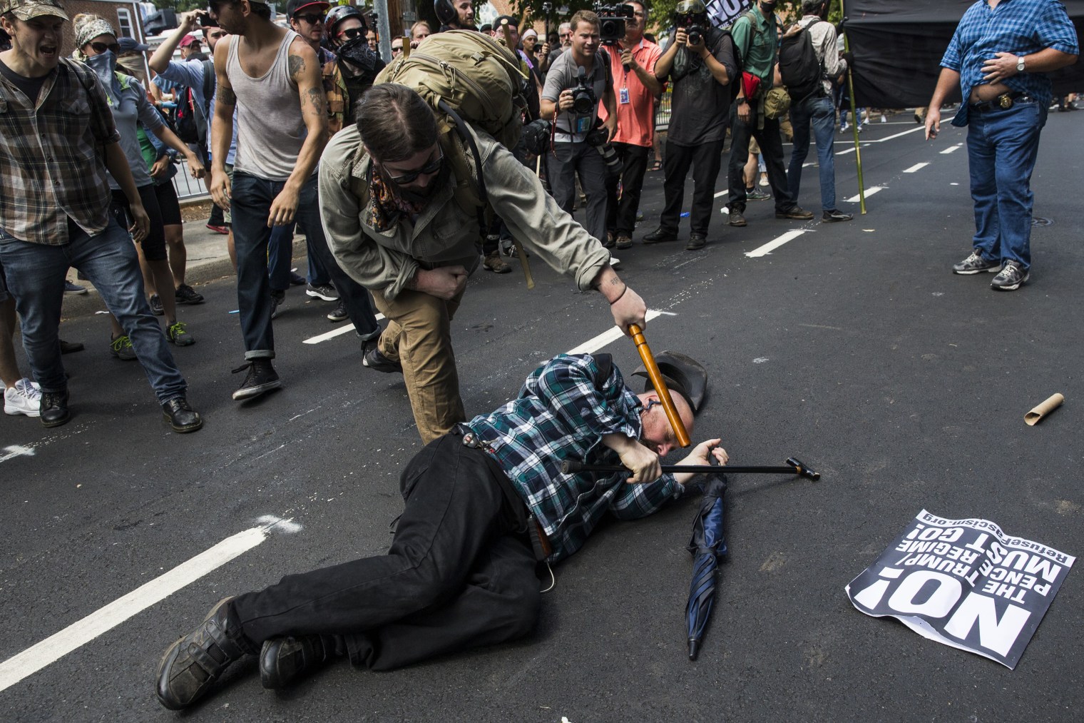 A counter-protester strikes a white nationalist with a baton during clashes surrounding a rally protesting the removal of the Robert E. Lee monument in Charlottesville, Va., on Aug. 12, 2017.