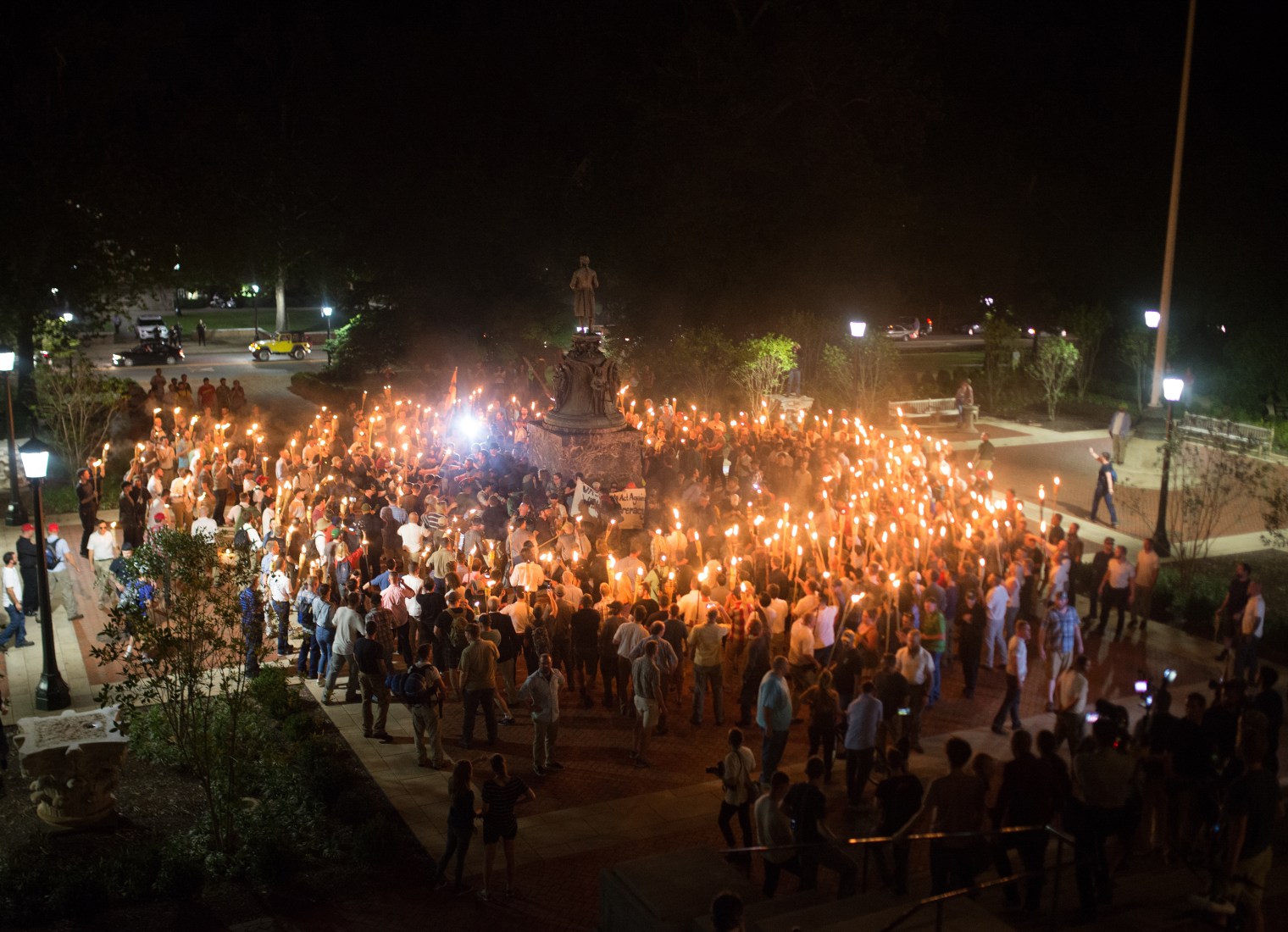 White nationalists encircle counter-protestors at the base of a statue of Thomas Jefferson after marching through the University of Virginia campus with torches in Charlottesville, Va., on Aug. 11, 2017. 