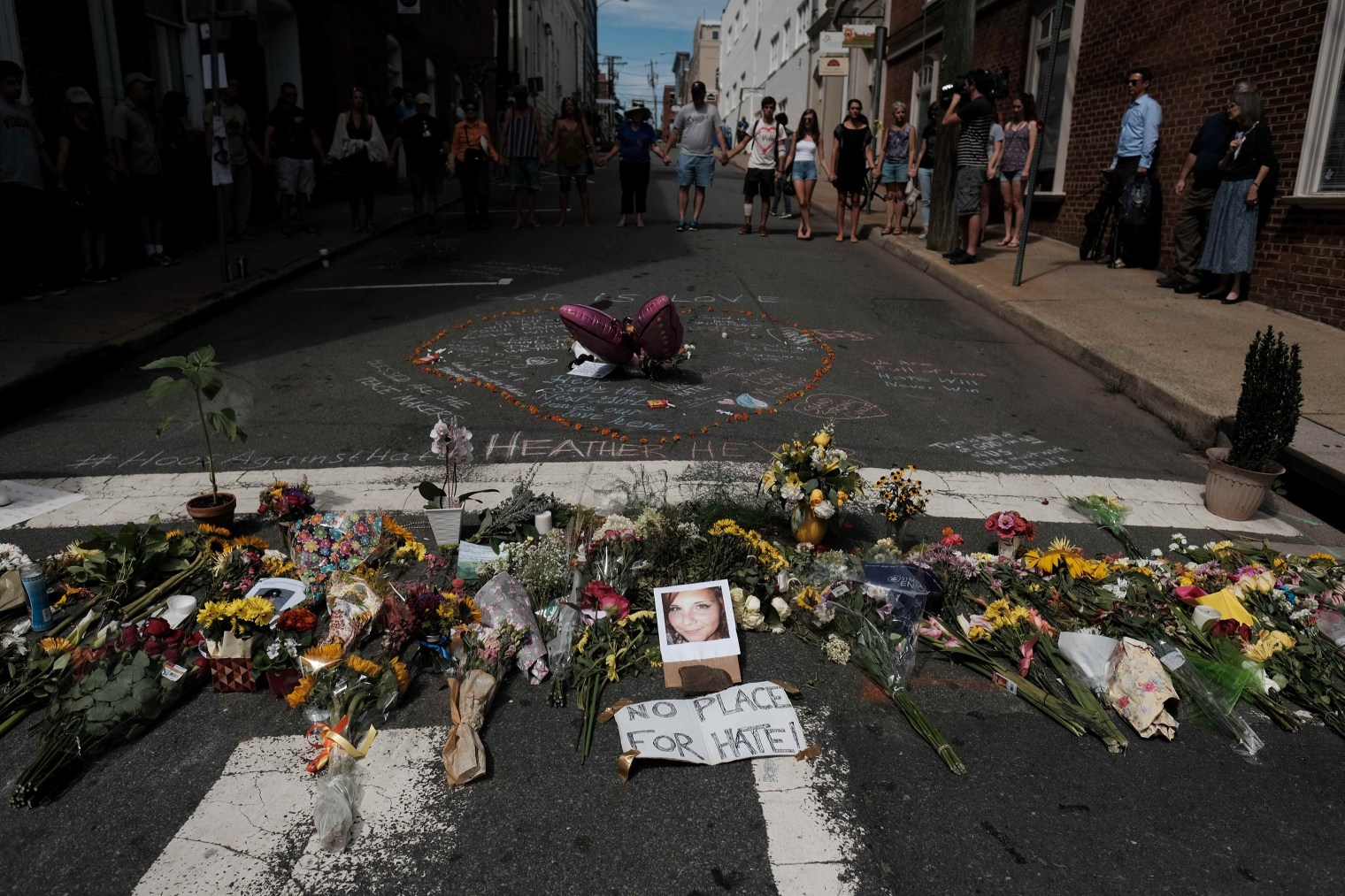 Flowers and a photo of car-ramming victim Heather Heyer lie at a makeshift memorial in Charlottesville, Va., on Aug. 13, 2017.
