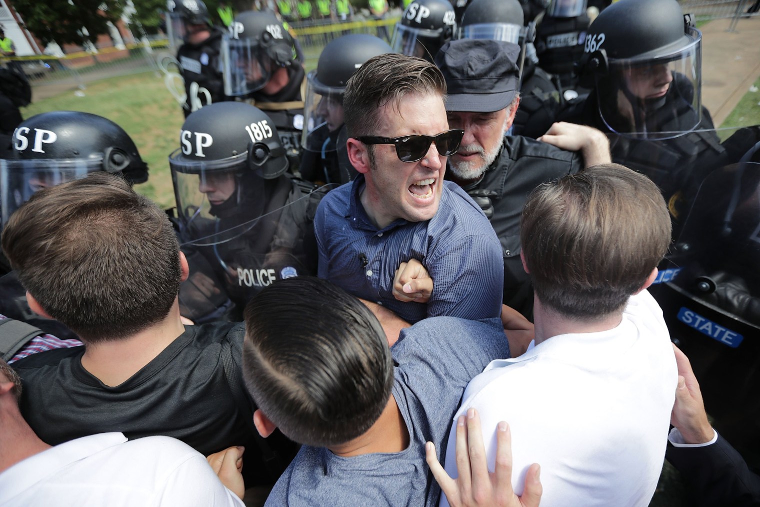 White nationalist Richard Spencer and his supporters clash with Virginia State Police in Lee Park after the 