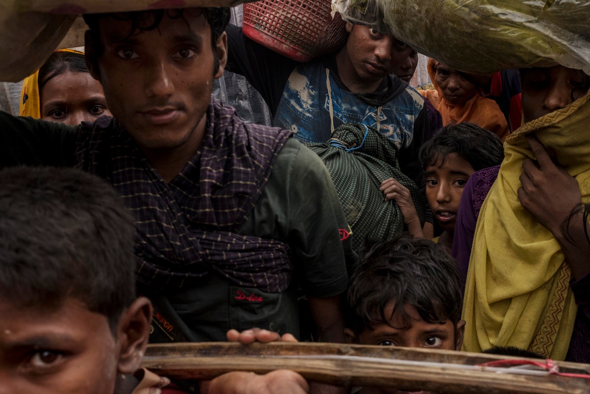 Rohingya refugees wait in line to be allowed by Bangladesh border guards to enter Unchiprang village after crossing the border into Bangladesh, September 1, 2017.