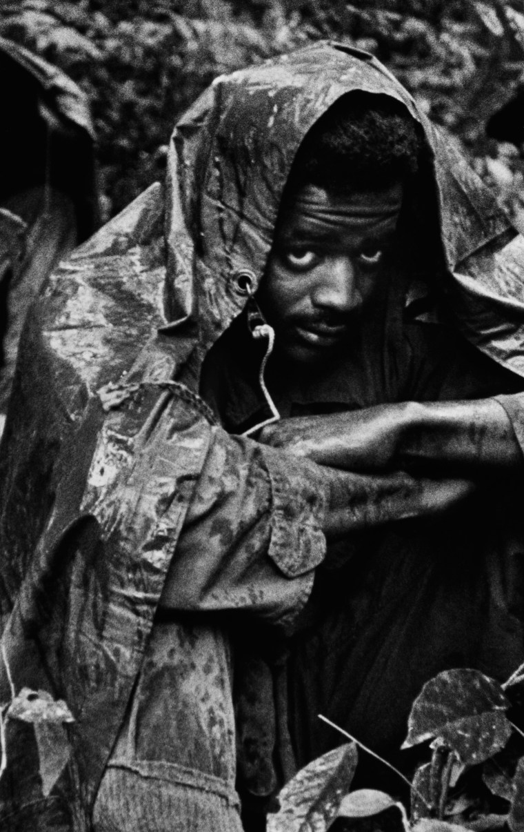 NEAR DA NANG â 1972: A GI on patrol in the jungles near Da Nang, South Vietnam, huddles under a poncho to escape the monsoon rains, 1972. (Photo by David Hume Kennerly)