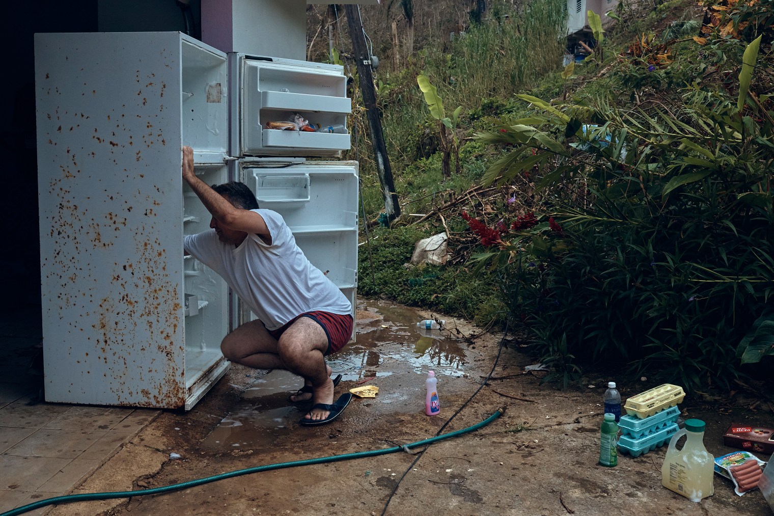 Gerardo Majero cleans his fridge in Morovis, Puerto Rico, on Oct. 1, 2017.